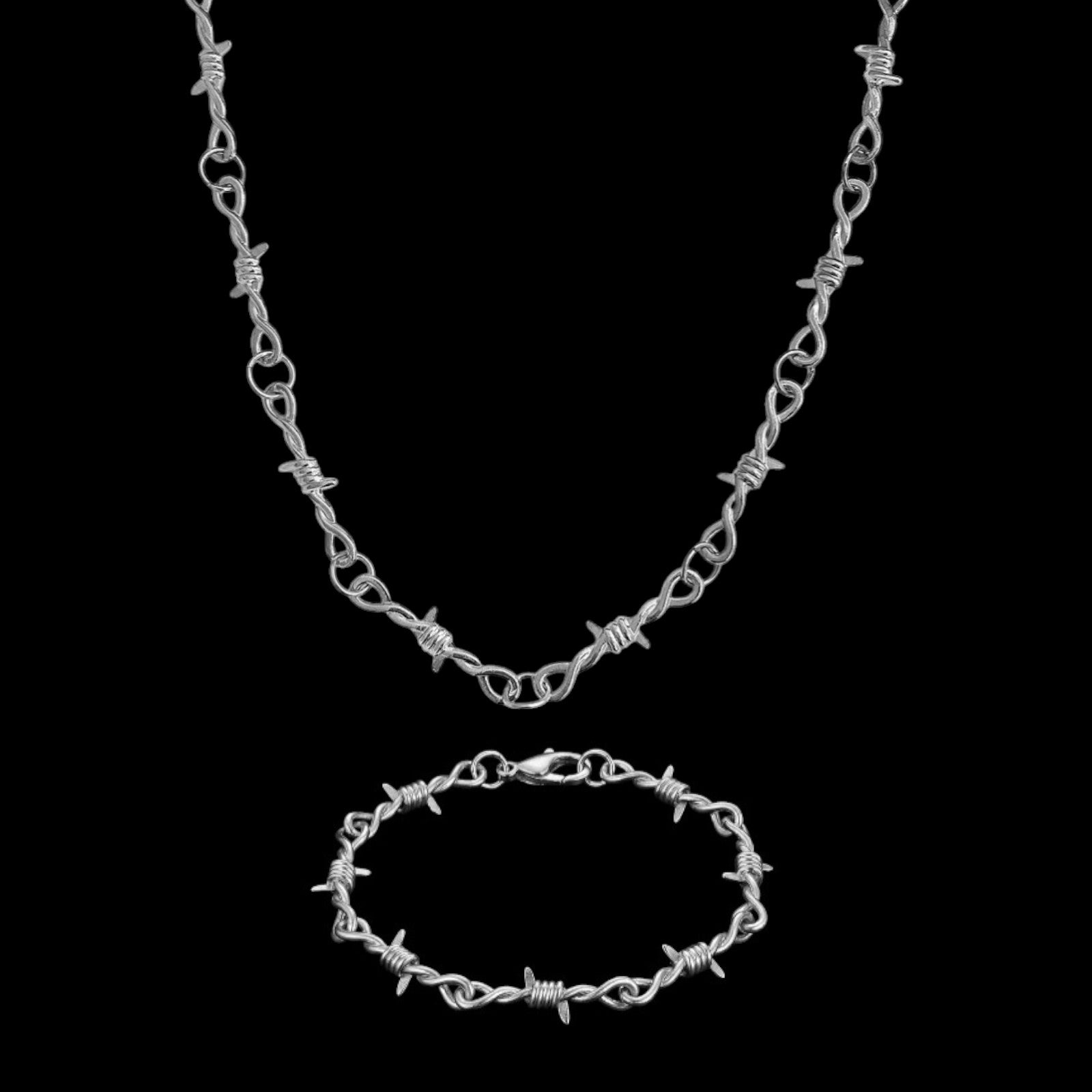 Barbed wire stainless steel jewelry set on a black background