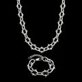 Berserk stainless steel jewelry set on a black background