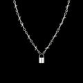 Barbed lock stainless steel necklace on a black background