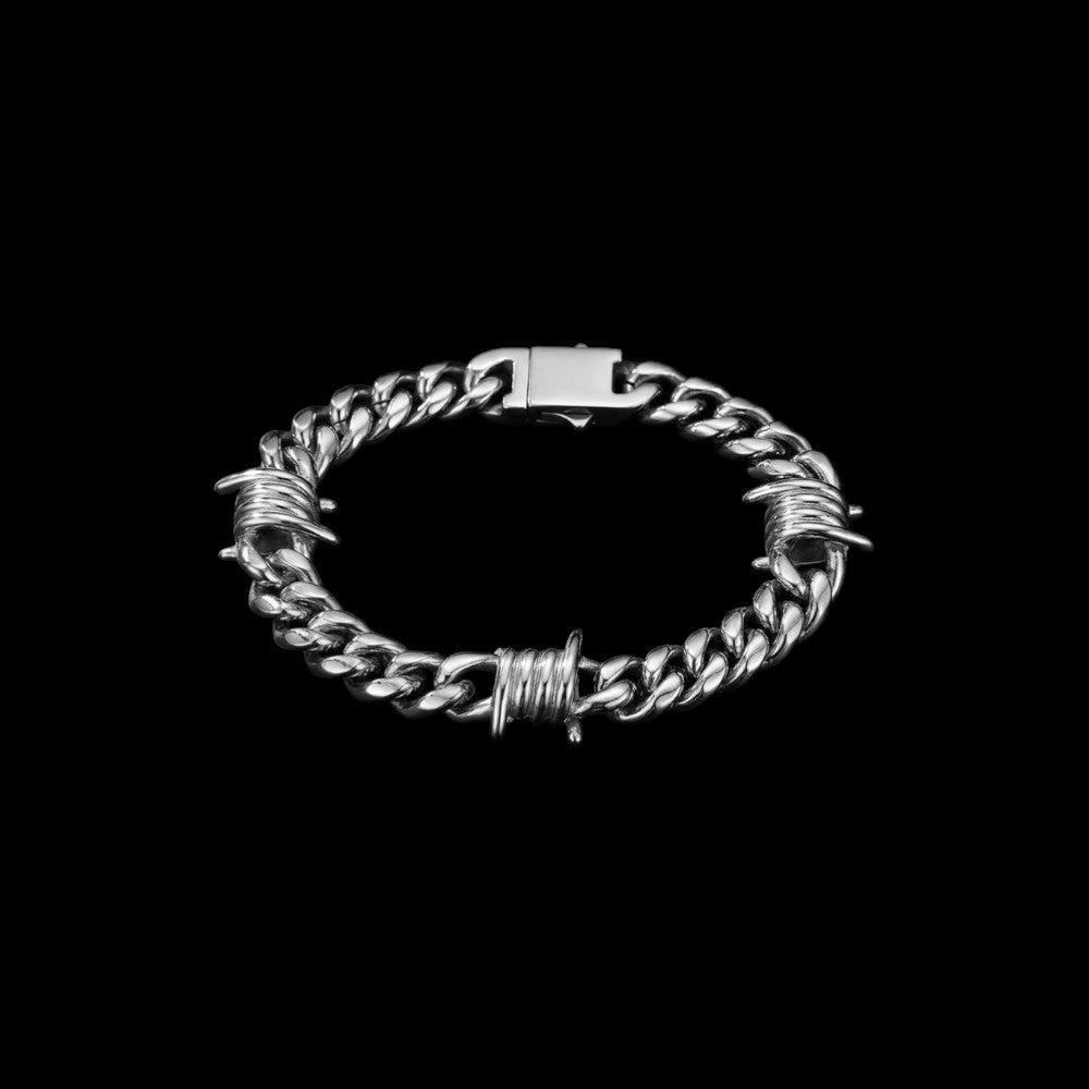 Barbed Cuban link stainless steel bracelet on a black background