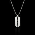 Razor blade stainless steel necklace on a black background