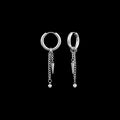 Rupture stainless steel earrings on a black background