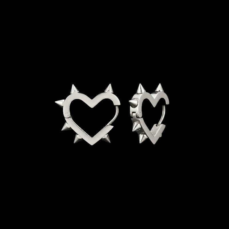 Love Kills spiked heart stainless steel earrings on a black background