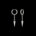 Impale spiked stainless steel earrings on a black background