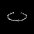 Barbed wire stainless steel bracelet on a black background