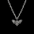 Death moth gothic stainless steel necklace on a black background