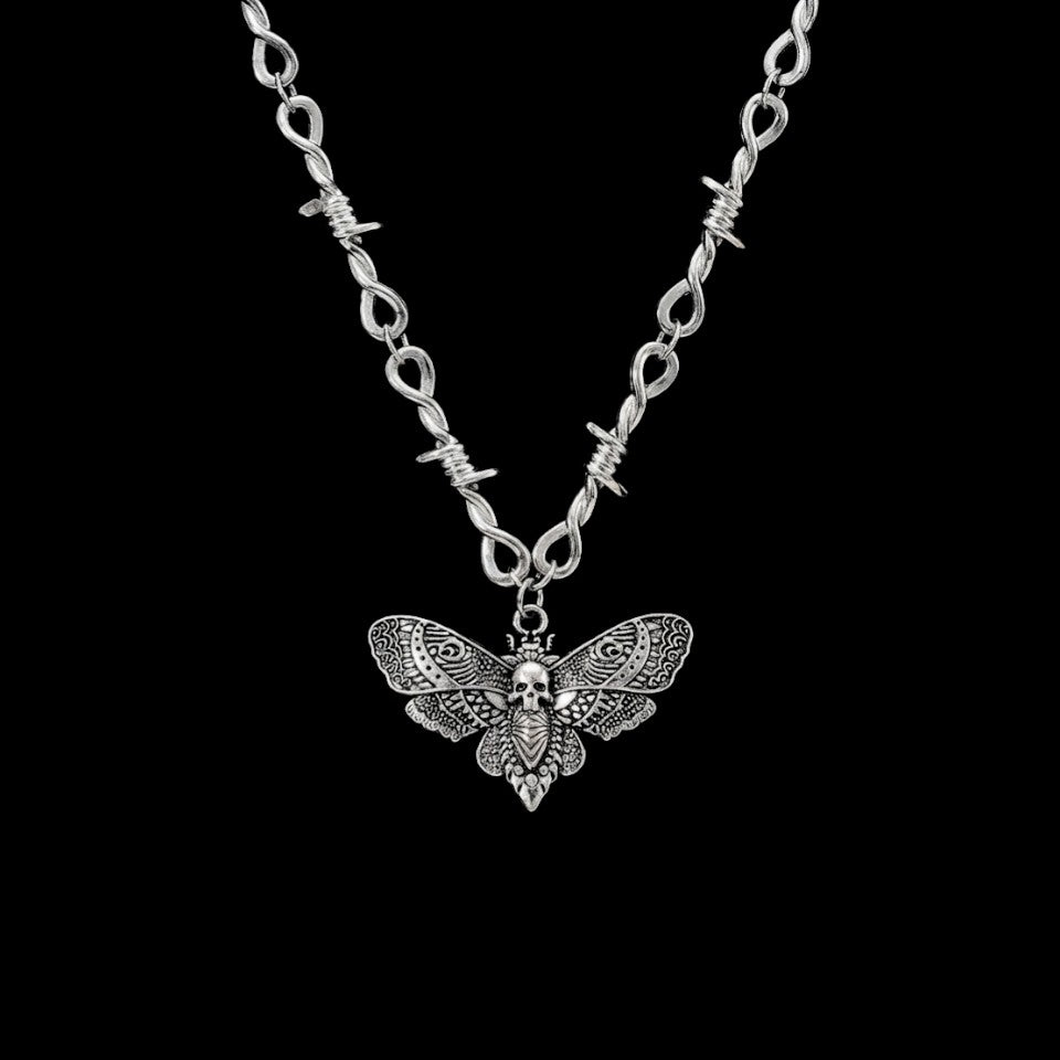 Death moth gothic stainless steel necklace on a black background