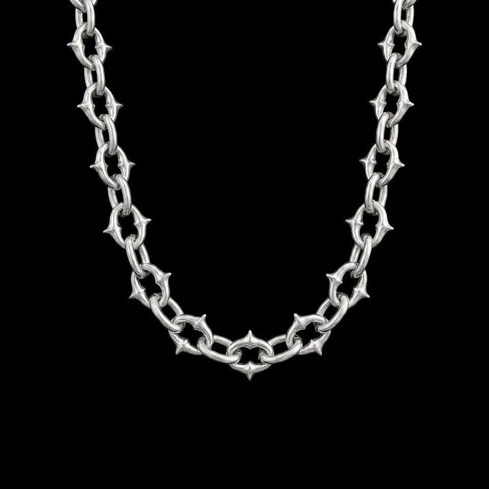 Berserk stainless steel chain necklace on a black background