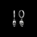 Death skull stainless steel hoop earrings on a black background