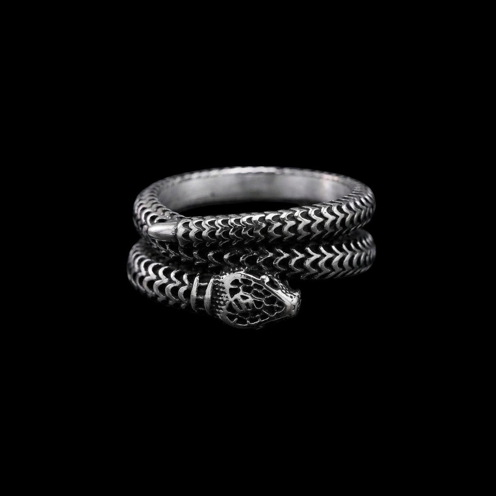 Coiled serpent stainless steel ring on a black background