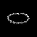 Bone stainless steel skull bracelet on a black background