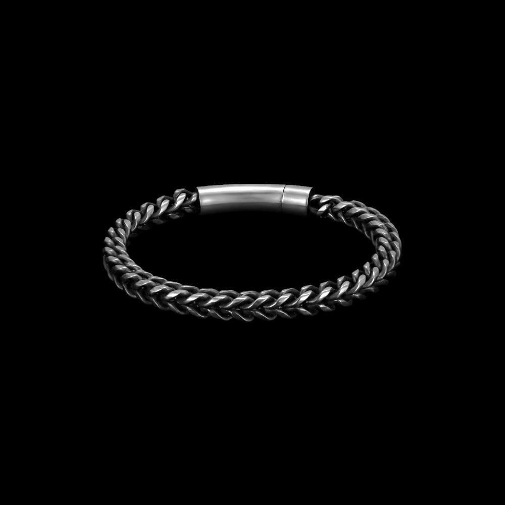 Chain-link stainless steel bracelet on a black background