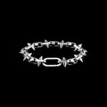 Rivet spiked stainless steel bracelet on a black background