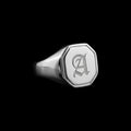 Custom hexagon signet stainless steel ring on a black background