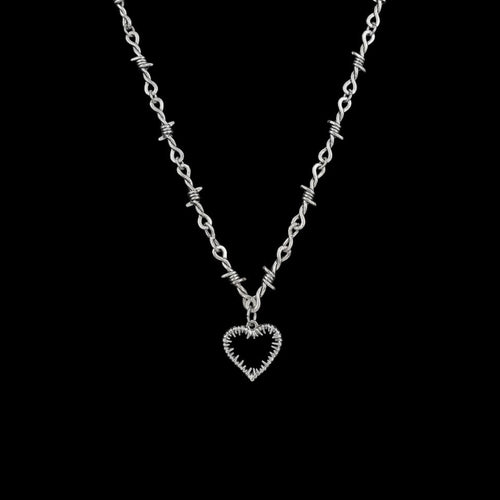 Barbed love stainless steel necklace on a black background