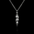 Impaled stainless steel skull and dagger necklace on a black background