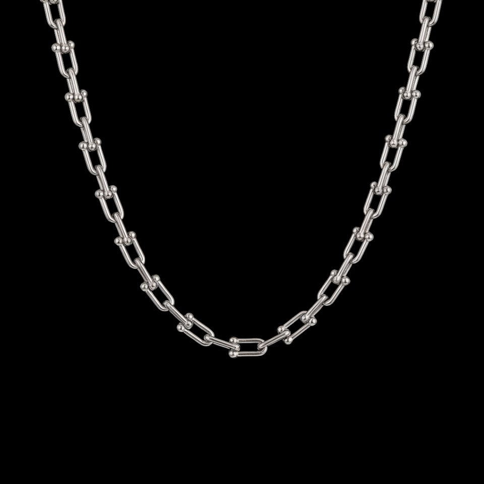Rebel clasp stainless steel necklace on a black background