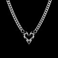 Barbed heart stainless steel necklace on a black background