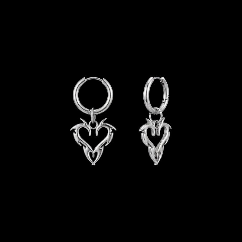 Barbed heart stainless steel hoop earrings on a black background