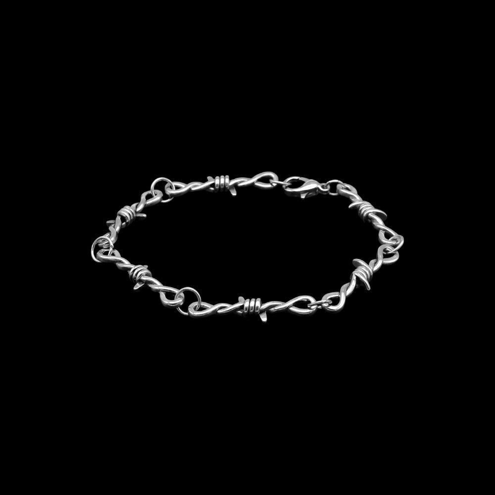 Barbed wire stainless steel cuff bracelet on a black background