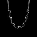 Lacerate stainless steel necklace on a black background