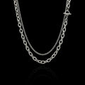 Layered statement stainless steel necklace on a black background