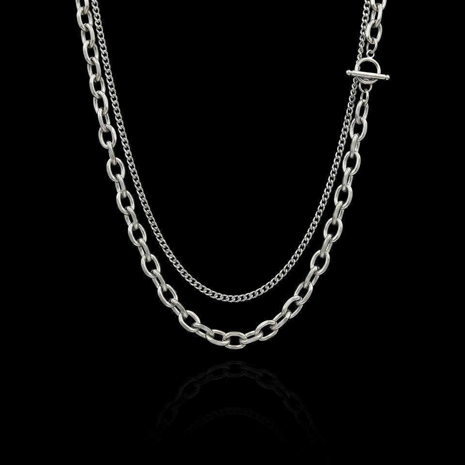 Layered statement stainless steel necklace on a black background