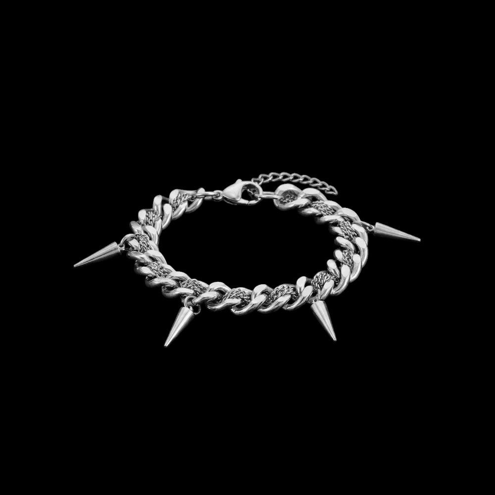 Spiked Cuban link stainless steel bracelet on a black background