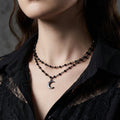 Crescent moon stainless steel choker on a black background